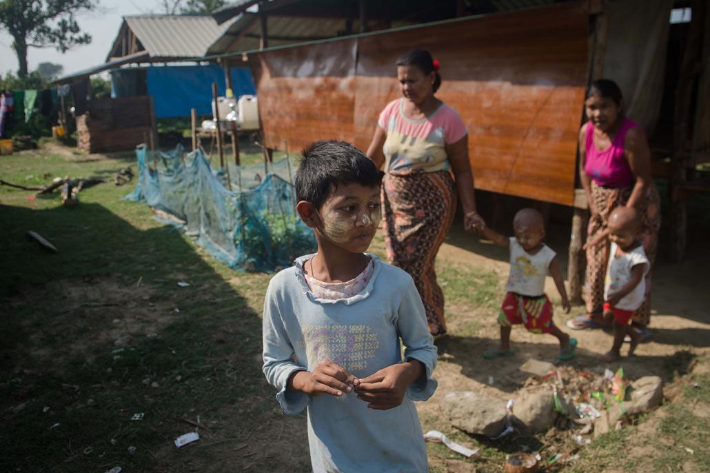 Rakhine villagers outside homes in Koe Tan Kauk. (AFP)