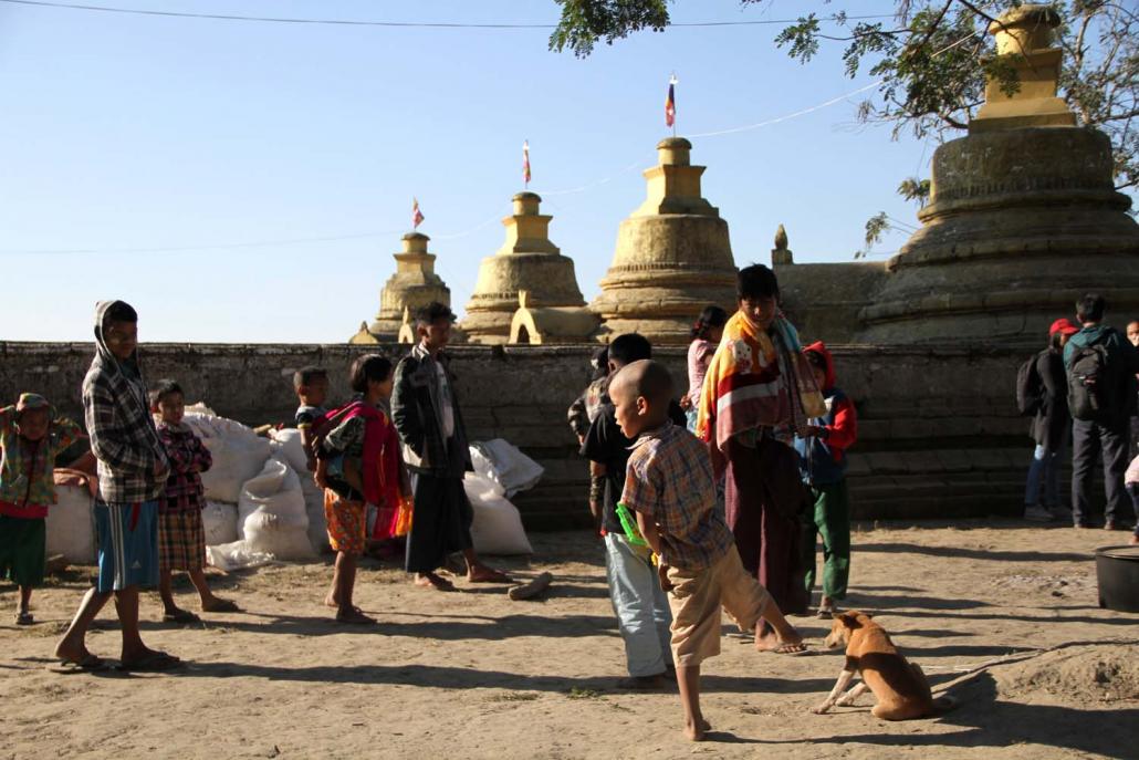 Ethnic Mro displaced from the surge of fighting between the Arakan Army and the Tatmadaw take refuge in the compound of a Buddhist pagoda on January 25. (AFP)