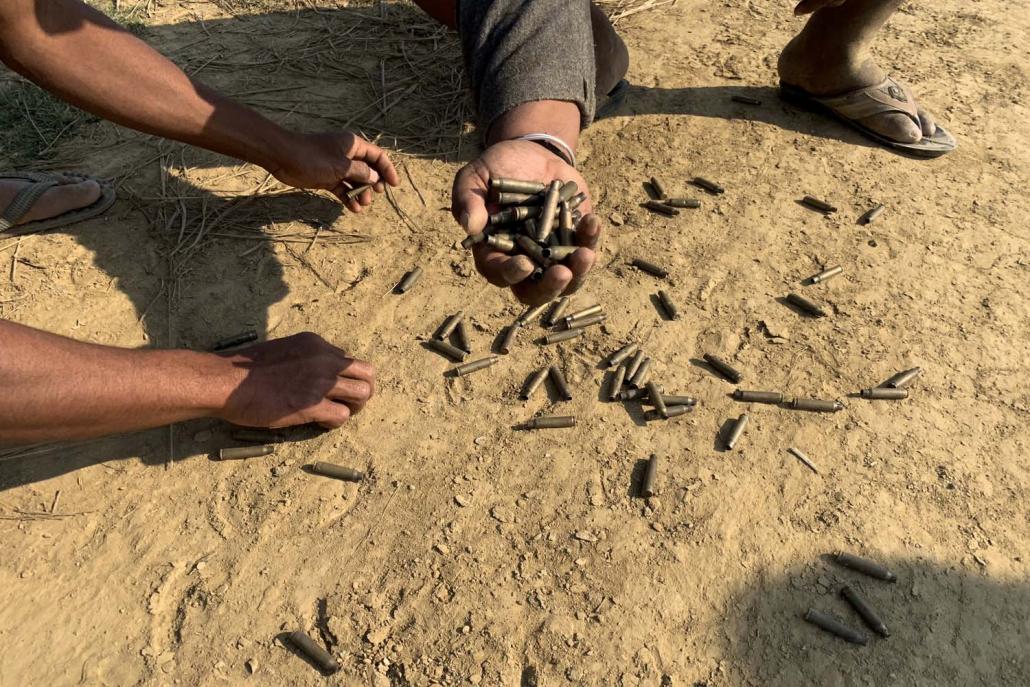 Residents hold bullet shells in a village in Rathedaung township, Rakhine State, after fighting between the Tatmadaw and Arakan Army in late January. (AFP)