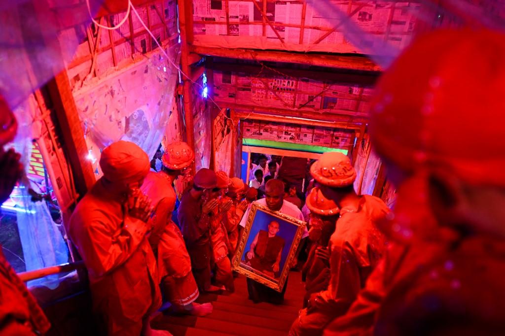 Devotees wait to carry the coffin of abbot Kay Lar Tha during his funeral. (AFP)