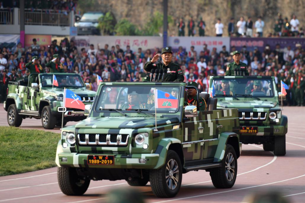 United Wa State Army leader Bao Youxiang waves to the crowd. (AFP)