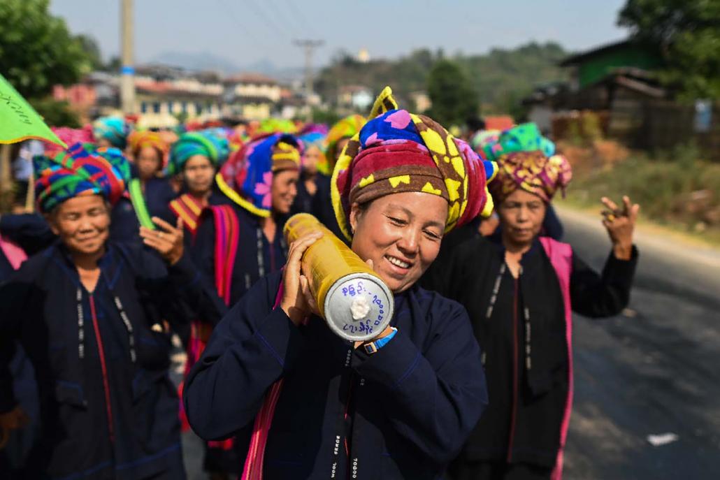 Pa'O women dance as they bring a homemade rocket to launch. (AFP)