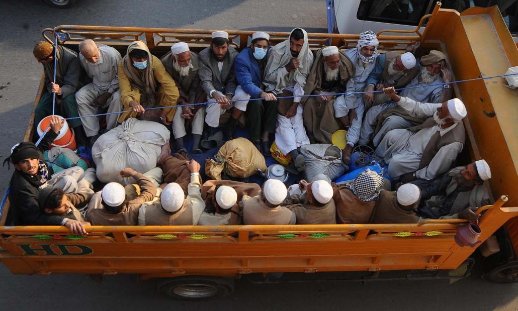 Pakistani Muslims ride a truck as they return after attending the four-day Tablighi meeting in Raiwind, some 25 kilometers from Lahore. (AFP)