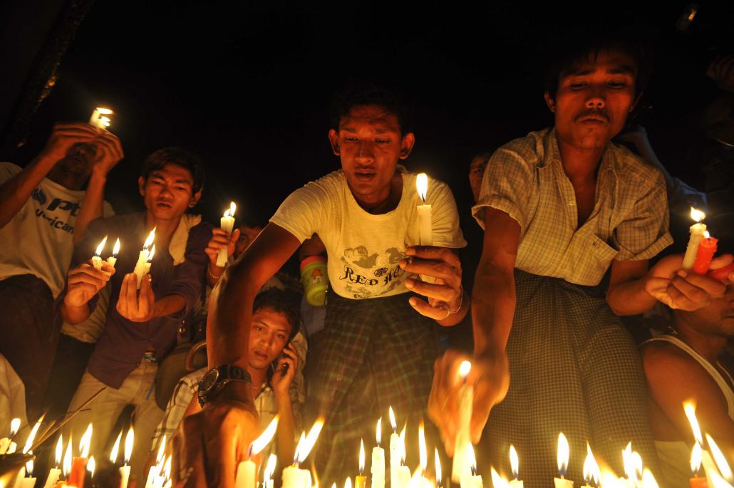 Demonstrators in Yangon hold candles to protest a government decision to raise electricity prices in November 2013. While removing subsidies is going to be unpopular, it’s considered an important and necessary reform. (Soe Than Win | AFP)