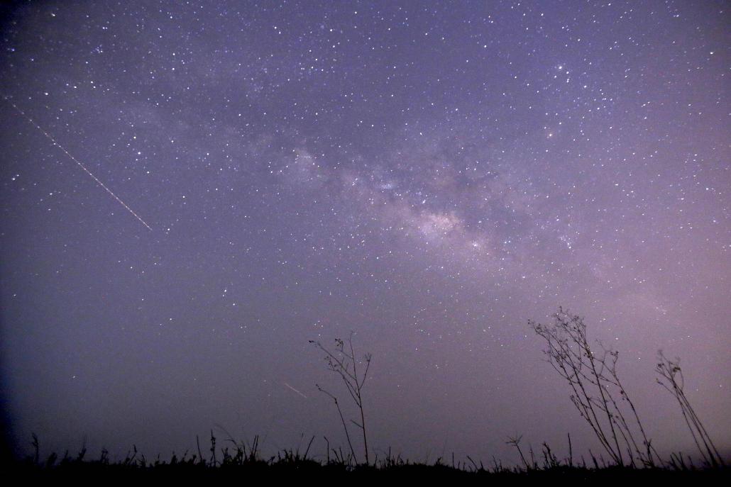 A long-exposure photograph shows a meteor shower passing near the Milky Way in the clear night sky of Thanlyin, on the outskirts of Yangon. (AFP)