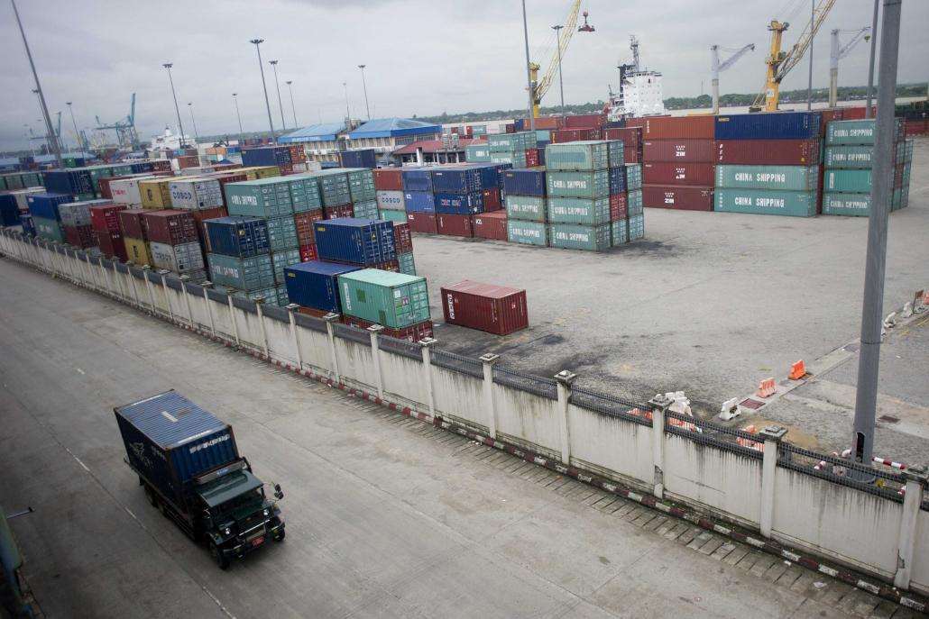 A truck drives past a cargo container yard at a port in downtown Yangon. (AFP)