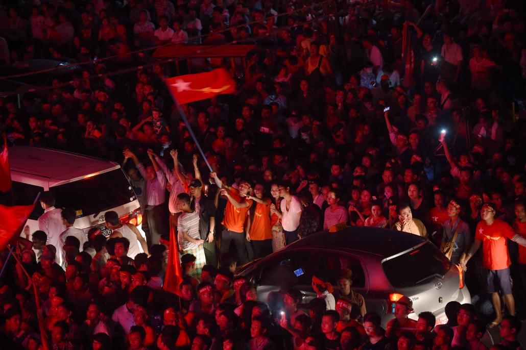 Supporters of the NLD gather outside the party's headquarters in Yangon on November 9, 2015, the day after the party's landslide victory. (Romeo Gacad / AFP)