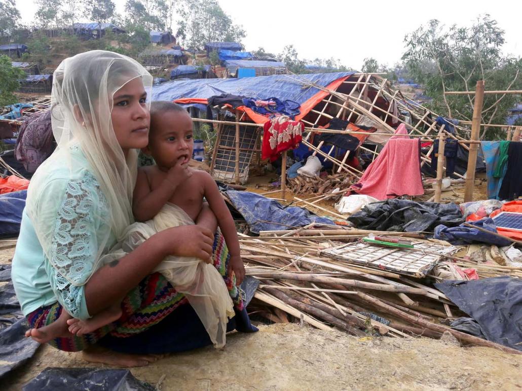 A Rohingya refugee sits near a house destroyed by Cyclone Mora in a camp in the Cox’s Bazar district on May 31, 2017. (AFP)