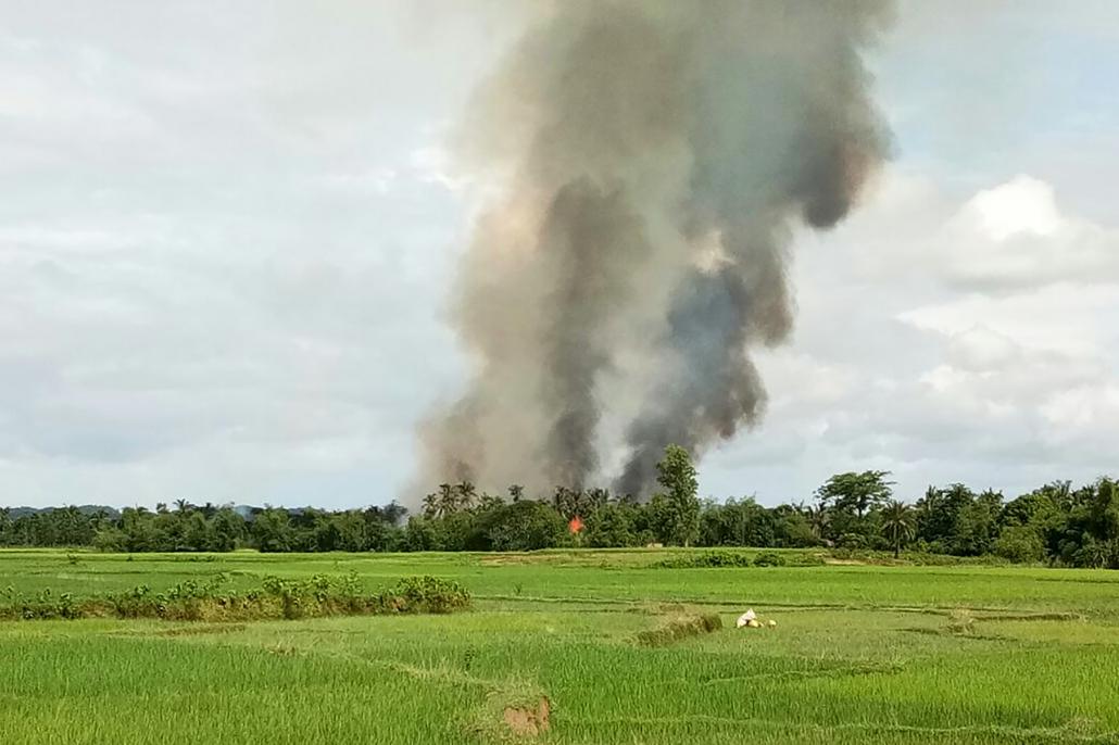 Smoke rises from what is believed to be a burning village in the area near Maungdaw on Wednesday. (AFP)