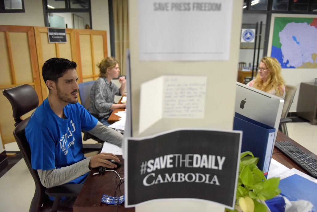 Journalists from the Cambodia Daily working in Phnom Penh shortly before the publication closed in September. (AFP)