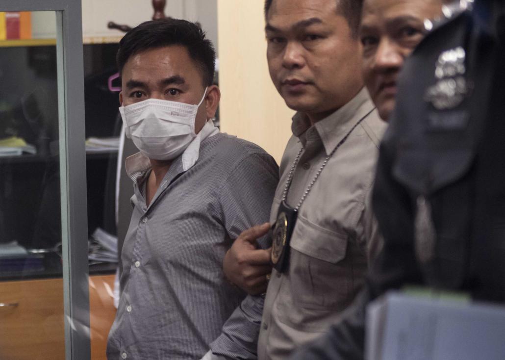 Boonchai Bach, 40, a Vietnamese national with Thai citizenship and alleged kingpin in Asia's illegal trade in endangered species, is handled by Thai police in Bangkok after his arrest on January 20, 2018. (AFP)