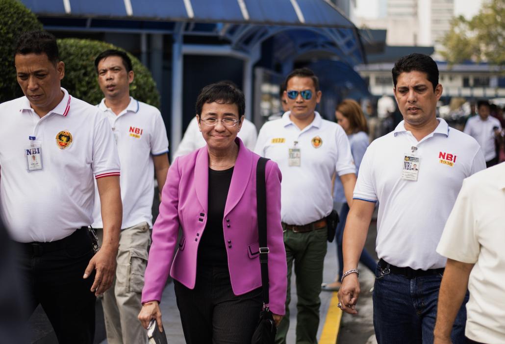 CEO of Philippine news website Rappler, Maria Ressa (centre), arrives at the National Bureau of Investigation (NBI) headquarters in Manila. (AFP)