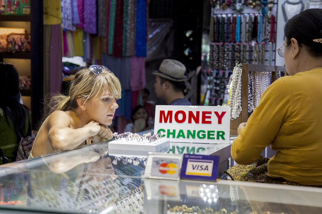 A tourist examines jewellery at a store in Bogyoke Market. (Theint Mon Soe / Frontier)