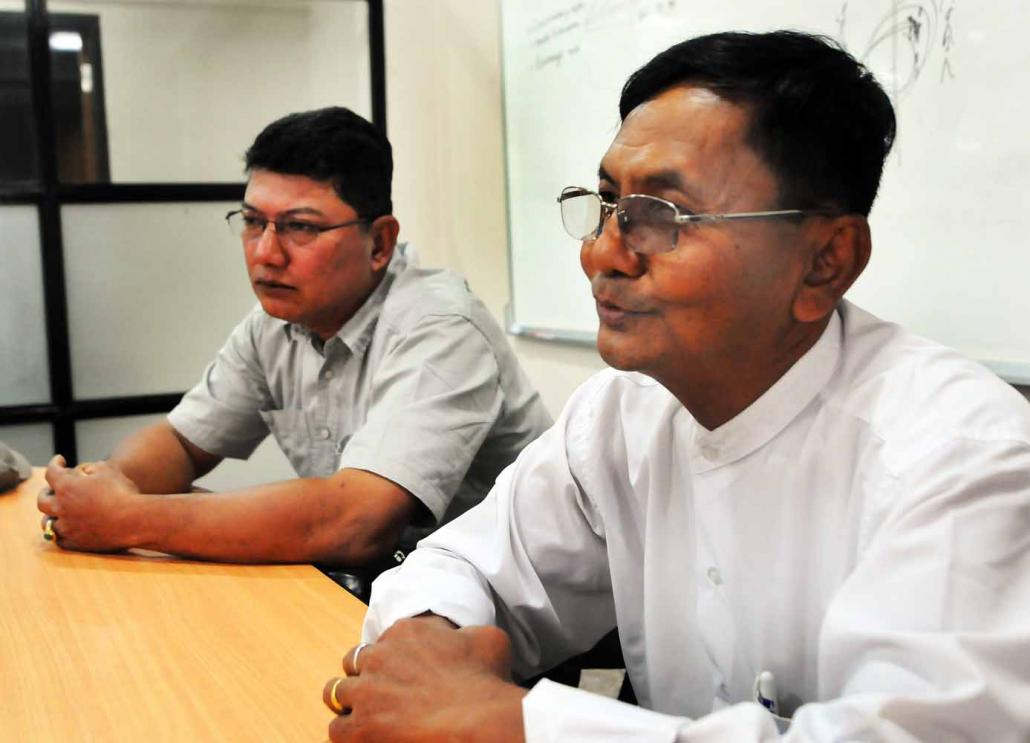 U Htay Nyunt, the managing director of First Myanmar private detective agency, together with U Khaing Soe, who leads its investigations in Yangon Region. (Steve Tickner | Frontier)