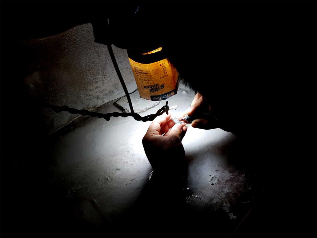 A jade carver crafts an object in Ruili. Myanmar exports mostly raw jade, which is then carved in China and Hong Kong. (Nyan Hlaing Lynn | Frontier)