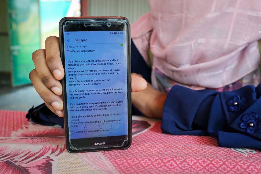 A young refugee shows a poem on her phone on August 6. Written just days earlier, it was her first attempt at poetry. (Victoria Milko | Frontier)