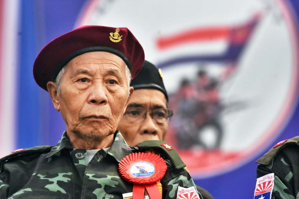 A decorated veteran of the Karen National Liberation Army sits onstage during the anniversary event on 31 January. (Steve Tickner | Frontier)