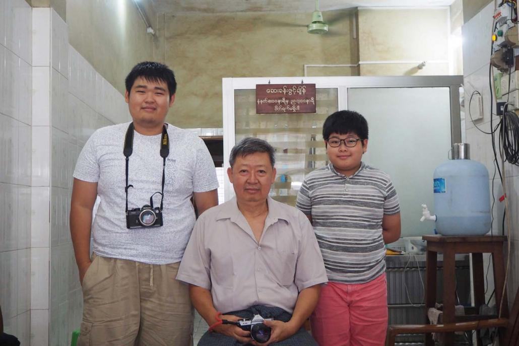 Analogue photography enthusiast Ko Thein Htike Zaw (left), aka Frederick Lee, with this father and fellow enthusiast U Aye Myint (centre) and younger brother, who goes by Alex Lee. (Tanvi Riise | Frontier)