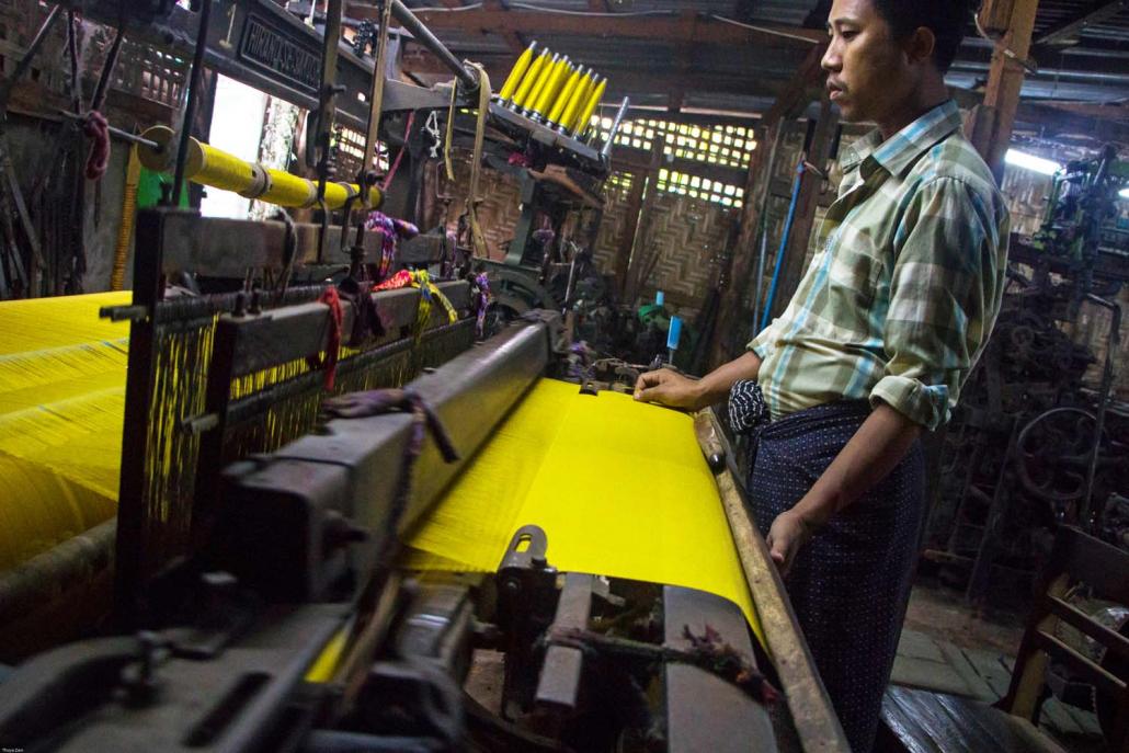 Weavers at Amarapura are struggling to compete with cheaper imported garments, some of which sell for less than a quarter of the price of intricately woven silk and cotton longyi and htamein created in traditional workshops. (Thuya Zaw | Frontier)