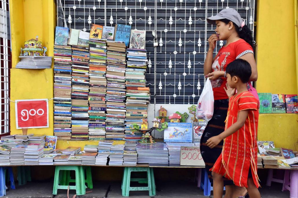 A streetside bookseller in downtown Yangon's Kyauktada Township. (Steve Tickner | Frontier)