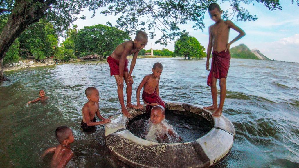 Young monks play in a flooded well in Sakyin. (Dominic Horner | Frontier)