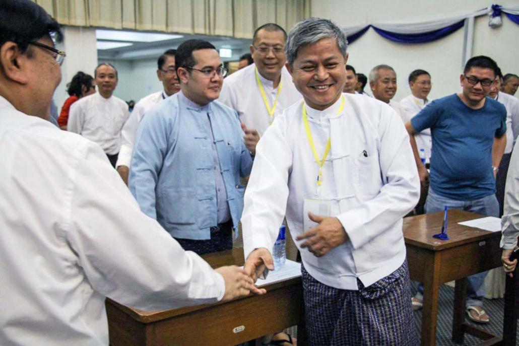 U Aung Kyi Soe is congratulated after being elected UMFCCI secretary general in 2016. (Nyein Su Wai Kyaw Soe | Frontier)