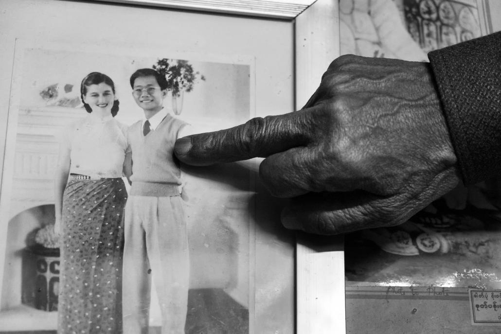 Sao Kya Seng’s younger brother, Sao Ohn Kyar, points to a photo of the royal couple taken soon after they arrived in Hsipaw from the US. (Brennan O'Connor / Frontier)