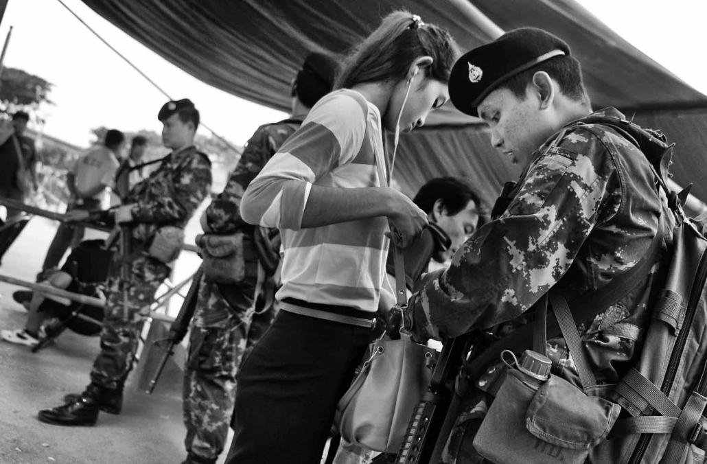 Thai soldiers conduct searches on migrant workers entering Thailand at Mae Sot from Myawaddy in Myanmar at one of the unofficial crossing points along the border. (Brennan O'Connor / Frontier)
