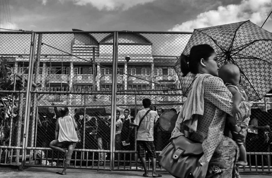 Migrant workers from Myanmar queue up to receive travel and work documents on the Thai side of the Friendship Bridge that connects the two countries