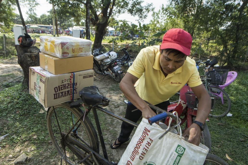 Ko Win Zaw Moe joined the Hlaing Tharyar Post Office 22 years ago, when he was just 15. (Teza Hlaing | Frontier)