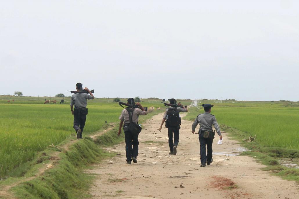 Police officer on patrol in Alae Than Kyaw village in Maungdaw Township last week. (Nyan Hlaing Lynn | Frontier)