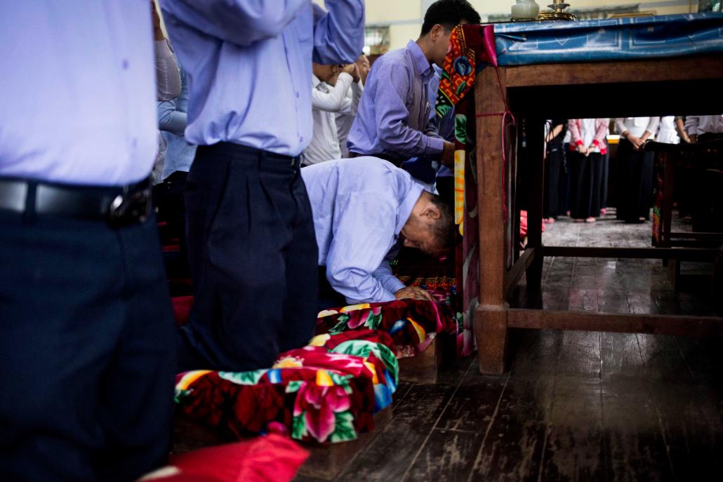 Aung Kyaw Oo takes part in prayers that mark the start of another school day. (Ann Wang / Frontier)