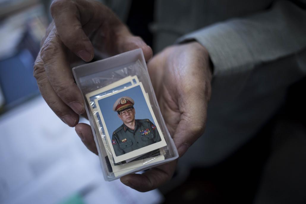 U David Abel shows a portrait from his early days in the Tatmadaw. (Ann Wang / Frontier)