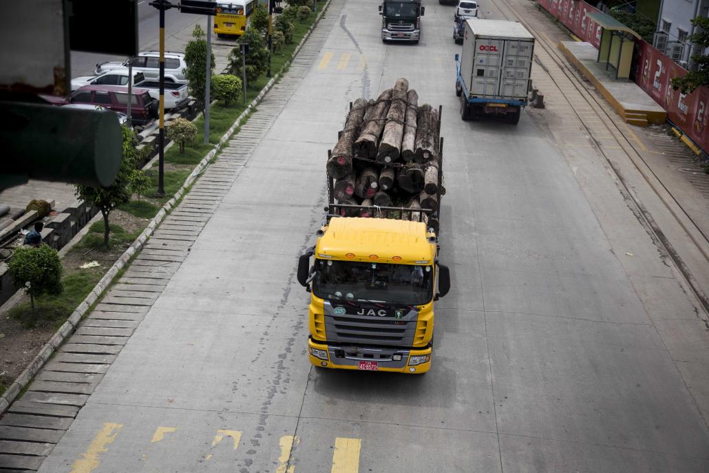 A logging truck travels down a road in downtown Yangon. (Ann Wang | Frontier)