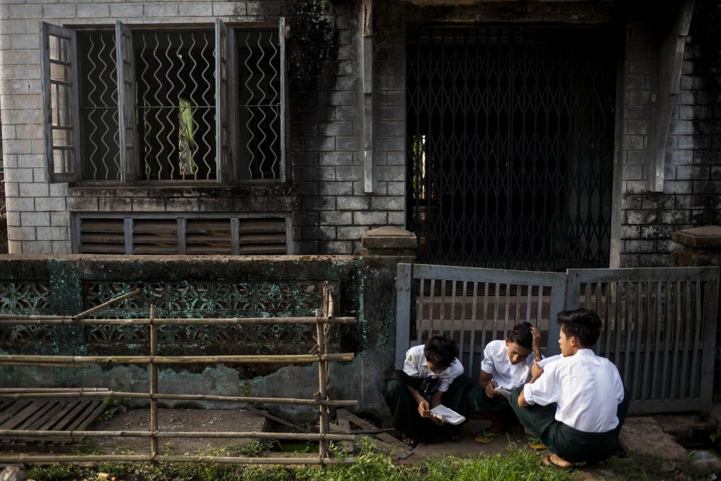 Students sit and study outside the Basic Education High School 8 in Bago. (Ann Wang / Frontier)