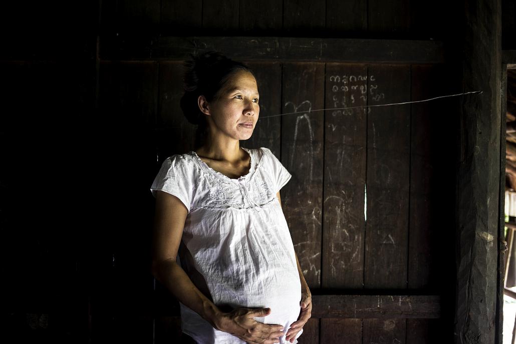 Ma Bu Atam, 40, from Nan Kham village is nine months pregnant with her fourth baby. All of her children were born without the help of a midwife, because there was no-one available during delivery. (Ann Wang / Frontier)