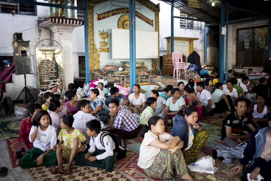 Sanchaung residents who lost their homes in the Gwa market fire take shelter in a nearby monastery in Yangon. (Ann Wang / Frontier)