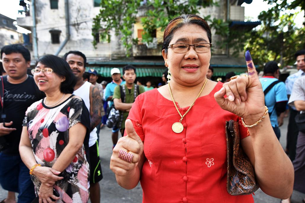 A voter shows her inked finger after casting her ballot in Tarmwe, Yangon. (Steve Tickner | Frontier)