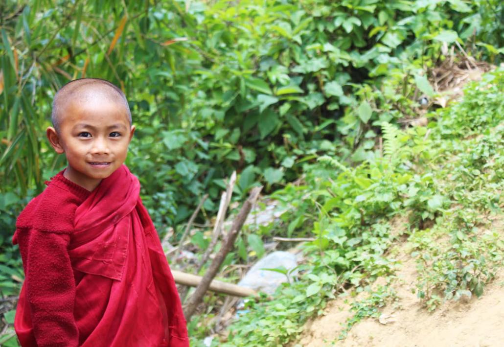 A novice Buddhist monk waits by the side of the road in the Naga SAZ. (Oliver Slow | Frontier)