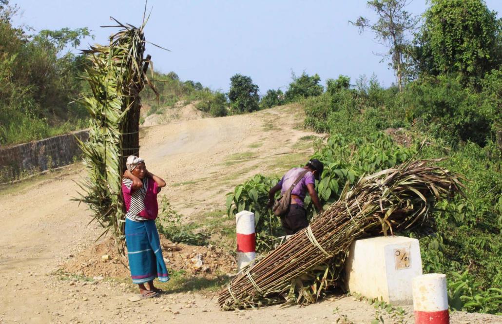 A villager carries goods on the road between Hkamti and Lahe. (Oliver Slow | Frontier)