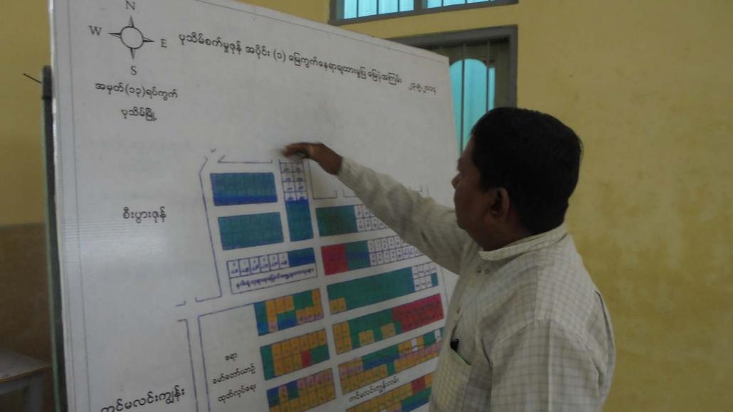 U Htay Lwin, secretary of the Pathein Industrial Zone Management Committee, points to a map of the zone. (Kyaw Ye Lynn | Frontier)