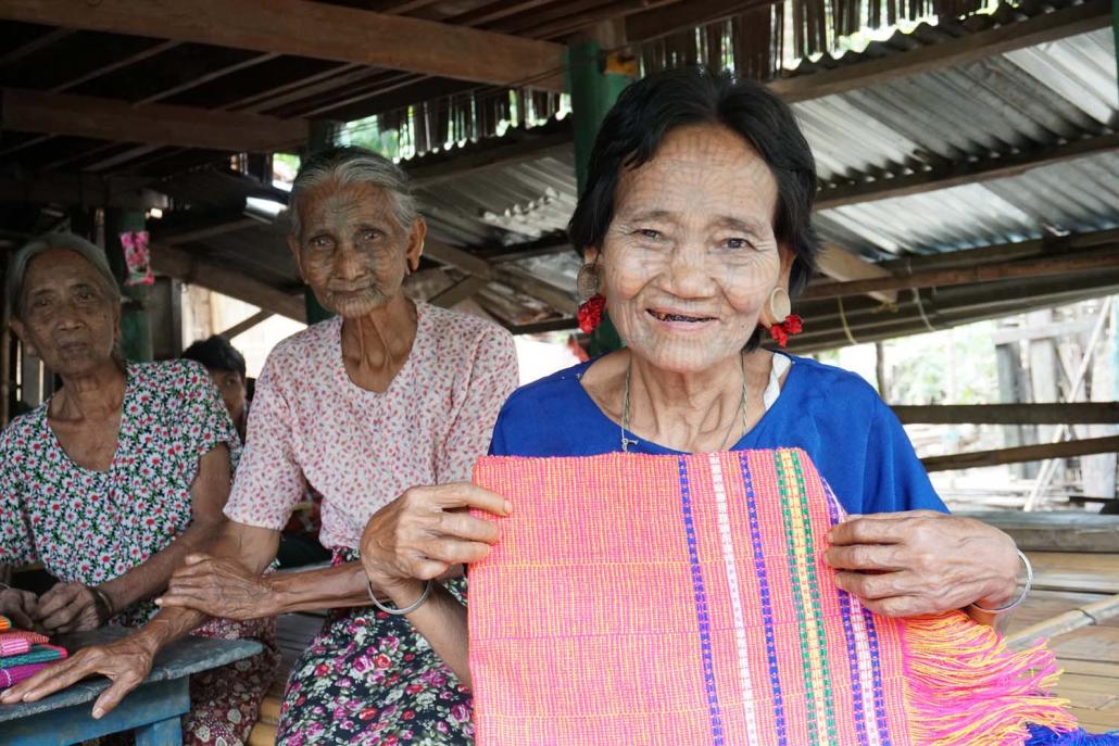 Daw Paw Lin holds a locally woven scarf. (Sharon Pun | Frontier)