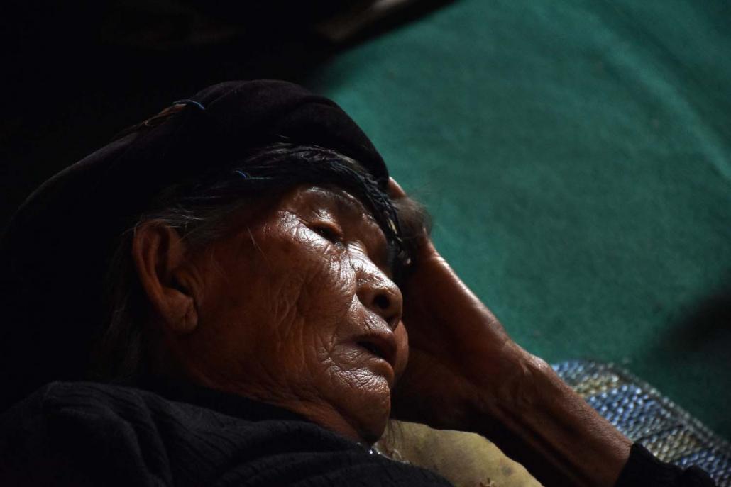 An elderly, ill Ta'ang woman in her 90s rests at Kho Lon monastery near Kutkai after fleeing fighting. (Steve Tickner | Frontier)