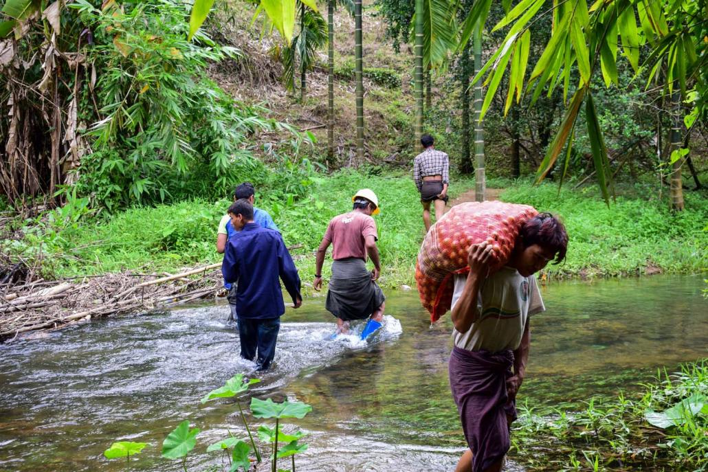 A man carries a bag of limes collected from trees in the community forest in Kot Hlaing for sale in Dawei. (Kyaw Lin Htoon | Frontier)