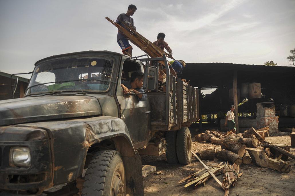 Residents of an IDP camp at Myaing Gyi Ngu return from working on a road construction project, their truck loaded with firewood to cook rice for camp residents. (Kyaw Lin Htoon | Frontier)