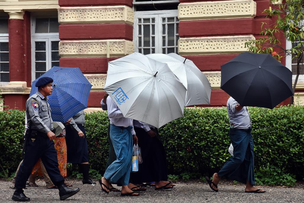 Defendants in a landmark judicial bribery case are led to a police van after a hearing at the Yangon Region High Court on November 9. (Steve Tickner | Frontier)