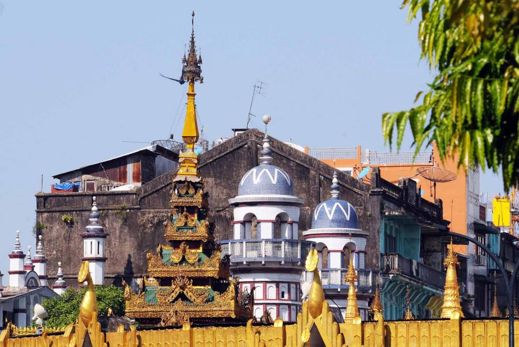 A mosque and a pagoda stand side by side in downtown Yangon. (Steve Tickner / Frontier)