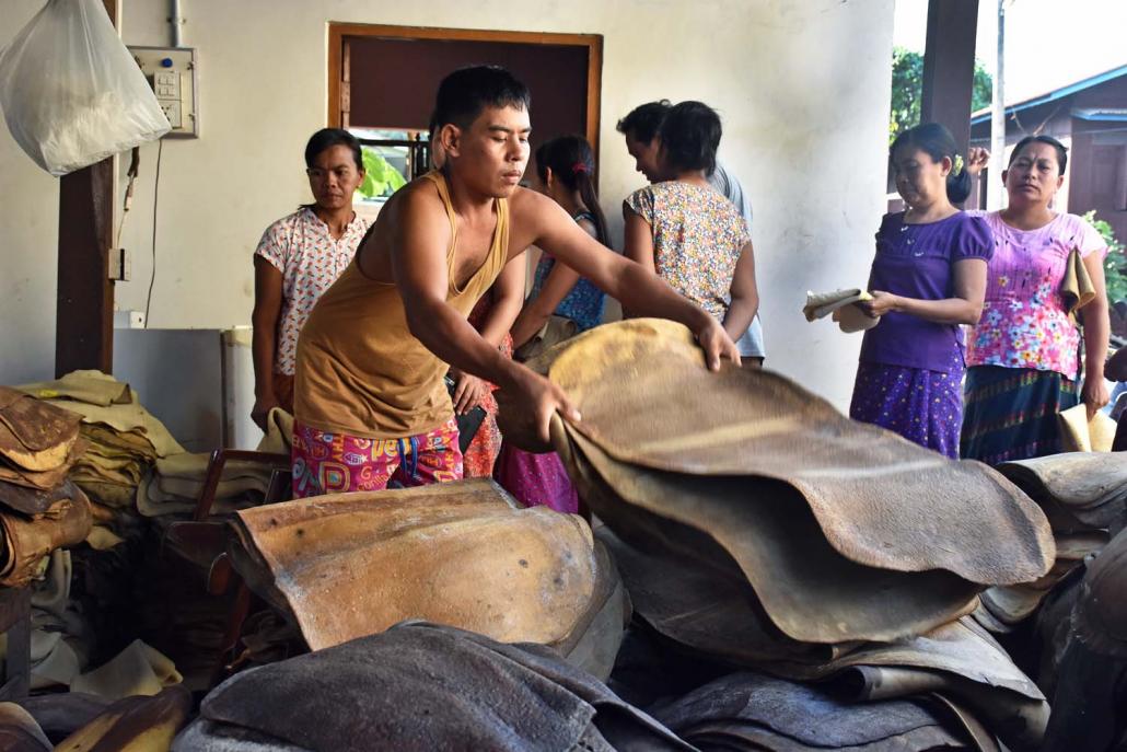 Workers at a rubber factory near the Mon State capital Mawlamyine. (Steve Tickner | Frontier)