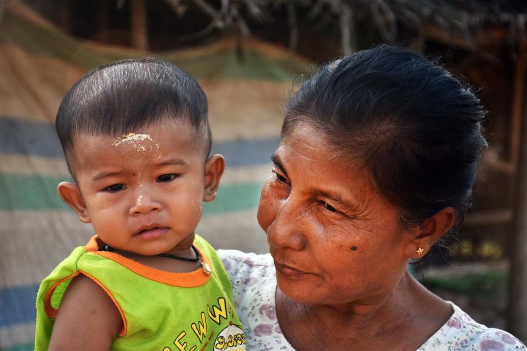 A Kaman woman and child attend the community’s water festival celebration in the Htaukkyant area of Yangon on April 13. (Su Myat Mon | Frontier)