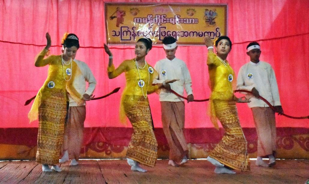 Young Kaman stage a performance for water festival. The bow carried by the men signifies their service as archers in the army of the Mrauk-U kings. (Su Myat Mon | Frontier)